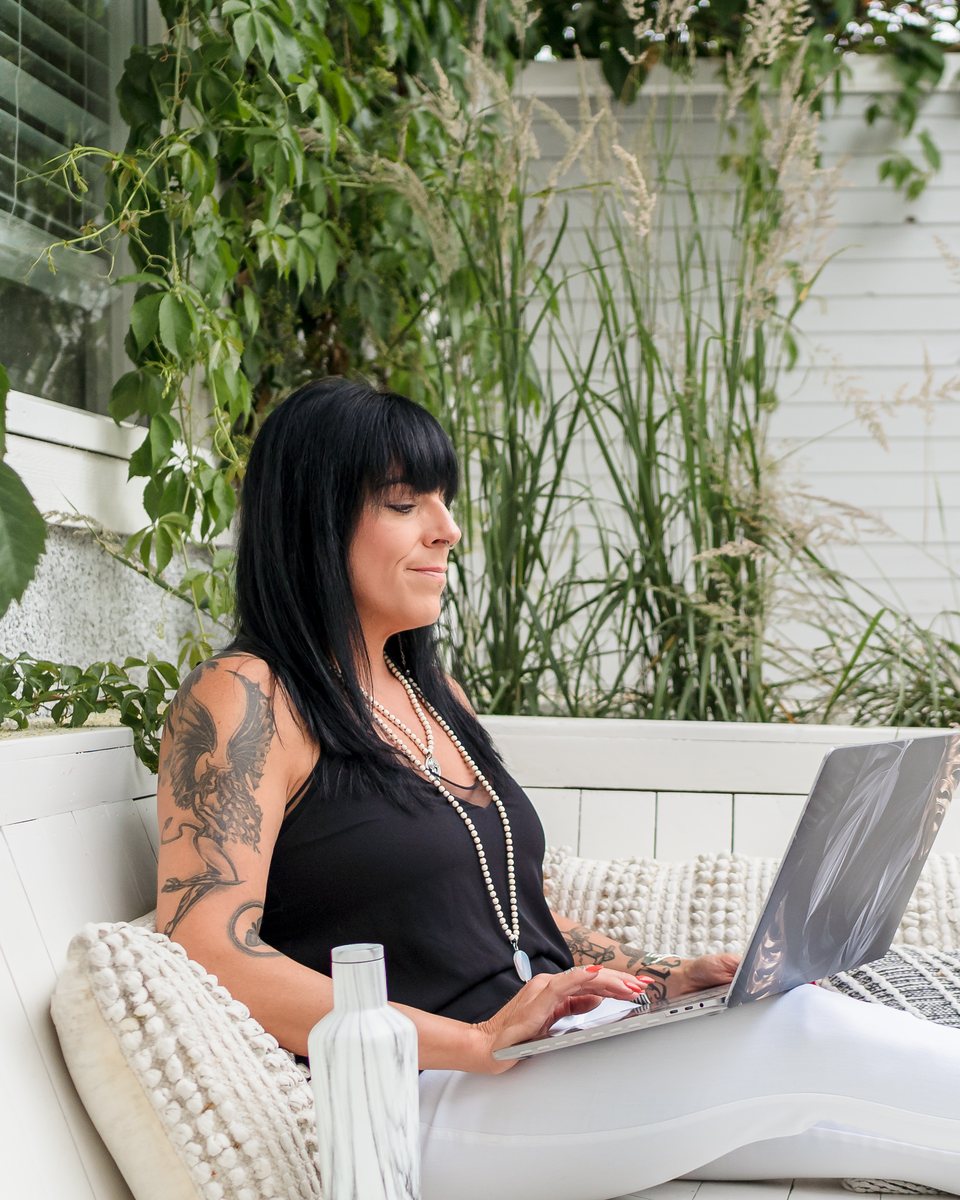 Cristina working on her laptop outdoors