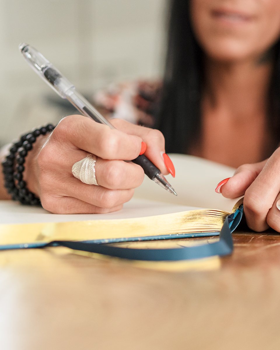 Writing in a journal, close up